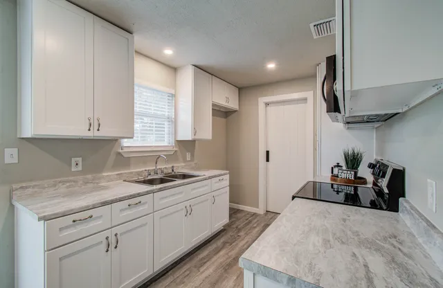 a kitchen with a sink and cabinets