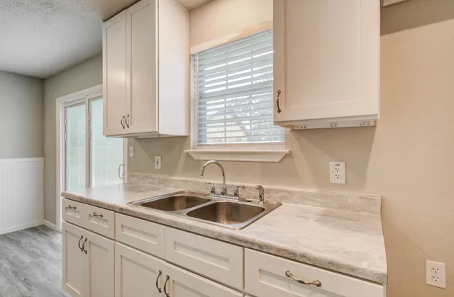 a kitchen with sink cabinets and window