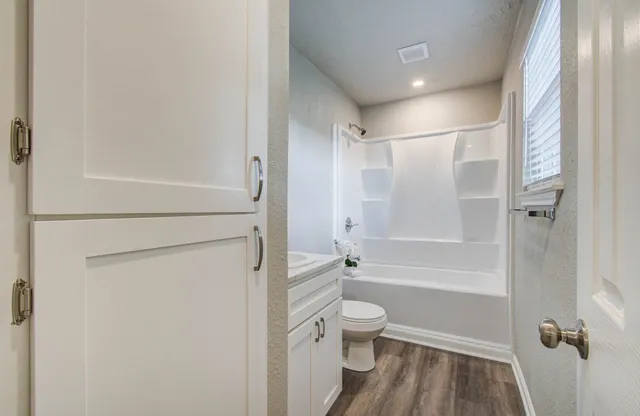 a bathroom with a toilet and a shower