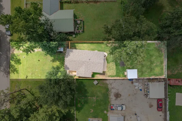 an aerial view of a house with a yard