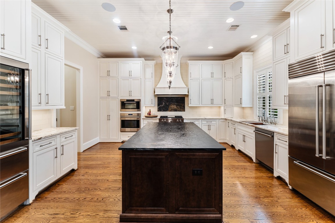 2109 Bancroft Lane Houston, TX 77027 - Photo 1 of 40 a kitchen with stainless steel appliances granite countertop a stove a refrigerator and a oven with wooden floor