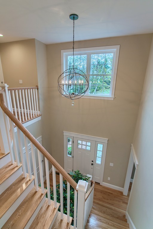 184 Gates Pond Road Berlin, MA 01503 - Photo 17 of 30 a view of a livingroom with wooden floor and stairs