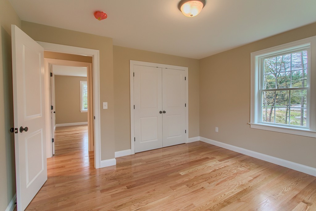 184 Gates Pond Road Berlin, MA 01503 - Photo 24 of 30 a view of an empty room with wooden floor and a window