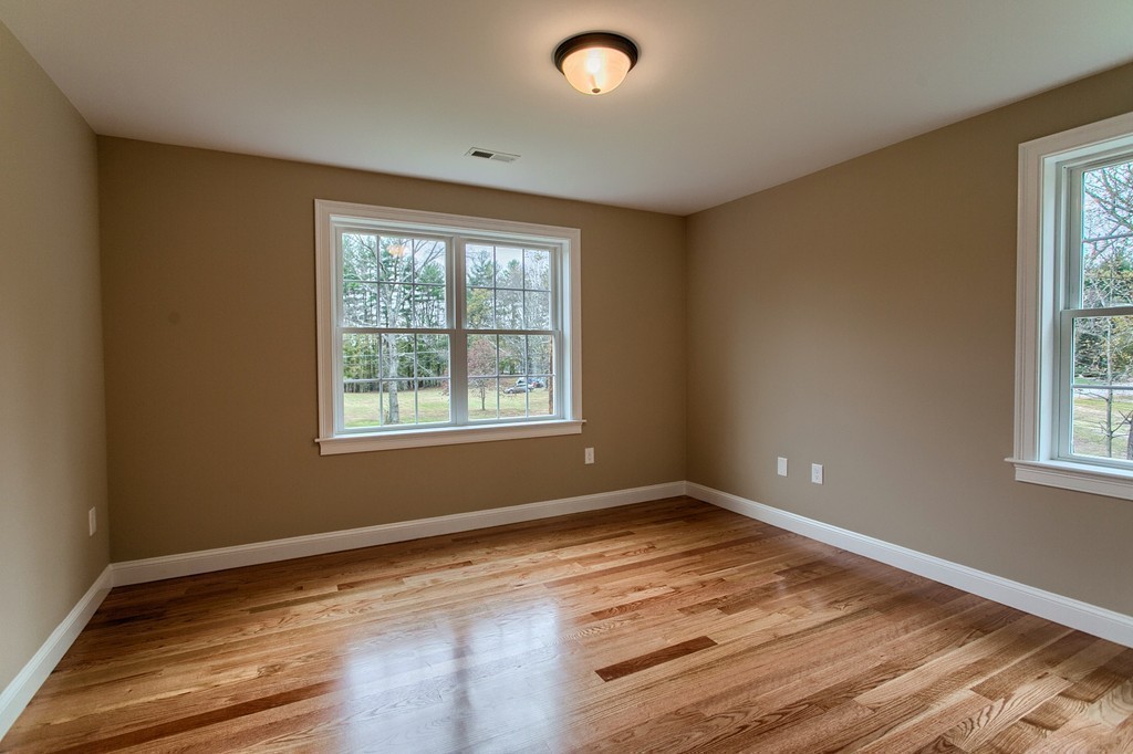 184 Gates Pond Road Berlin, MA 01503 - Photo 28 of 30 a view of empty room with wooden floor and fan