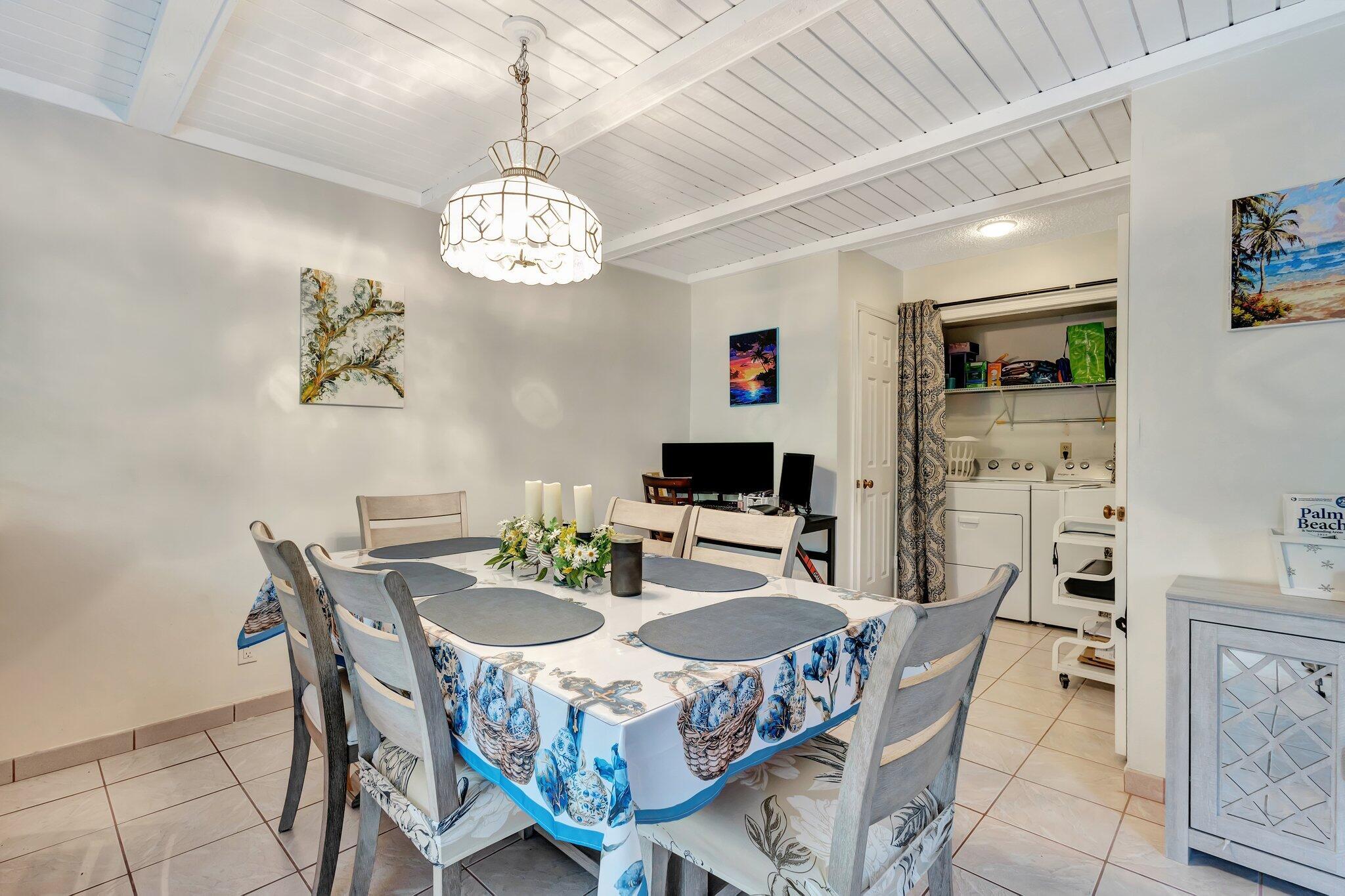 2936 Kirk Road Lake Worth Beach, FL 33461 - Photo 11 of 19 a view of a dining room with furniture a chandelier and wooden floor
