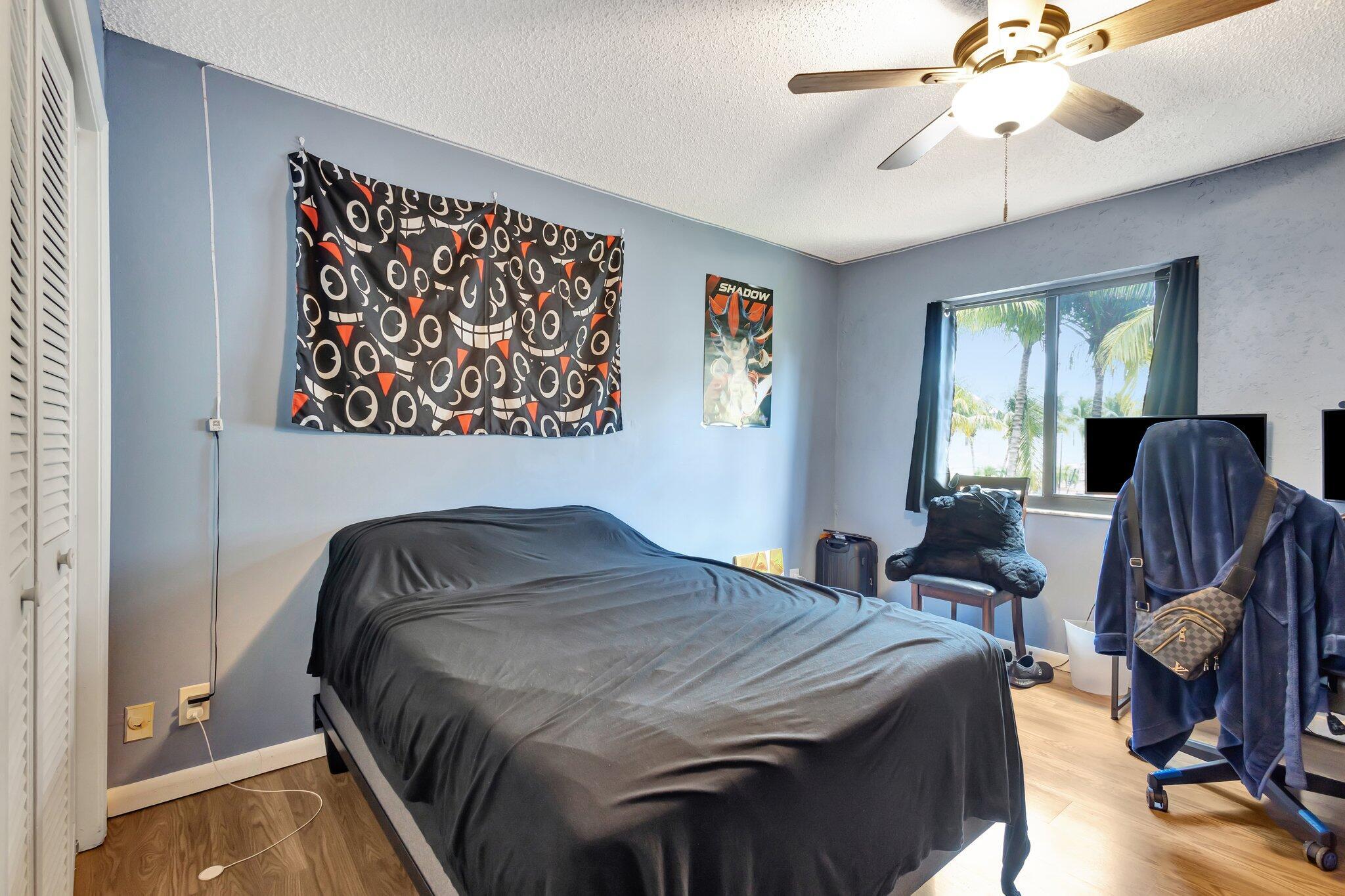 2936 Kirk Road Lake Worth Beach, FL 33461 - Photo 14 of 19 a bedroom with a bed and wooden floor