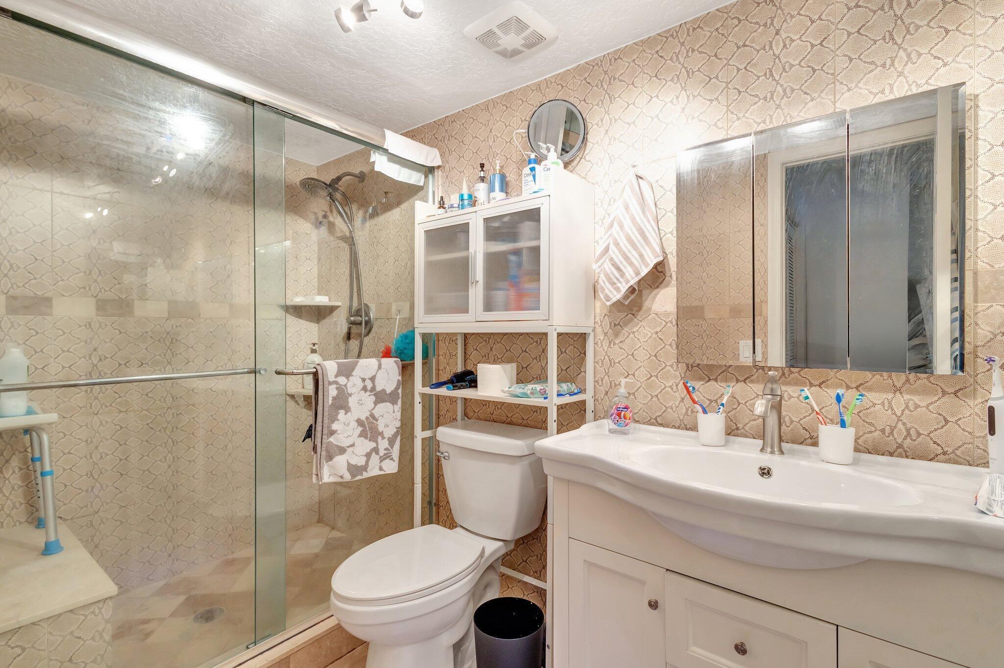 2936 Kirk Road Lake Worth Beach, FL 33461 - Photo 15 of 19 a bathroom with a sink toilet and shower