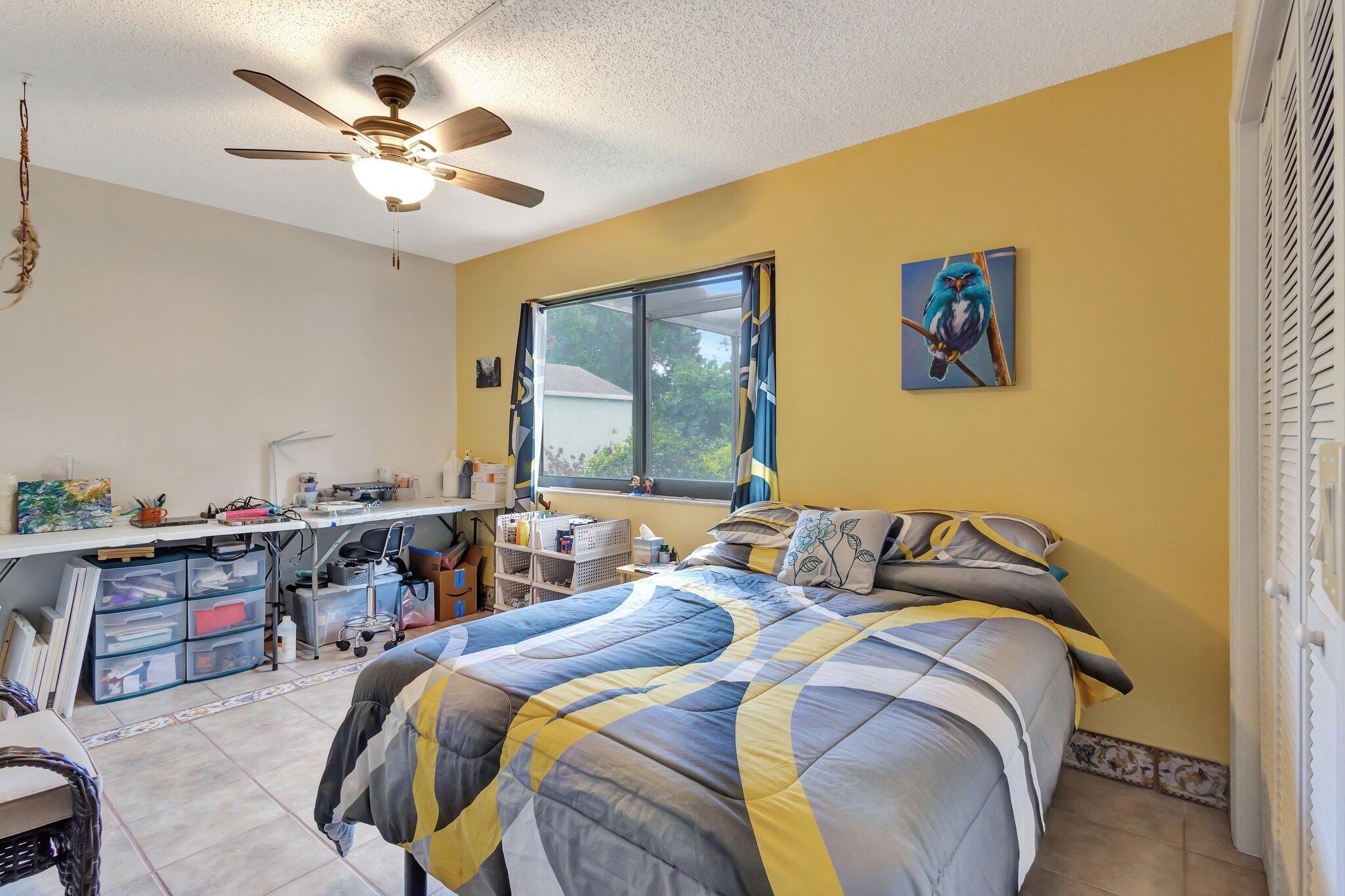 2936 Kirk Road Lake Worth Beach, FL 33461 - Photo 16 of 19 a bedroom with a bed and a chandelier