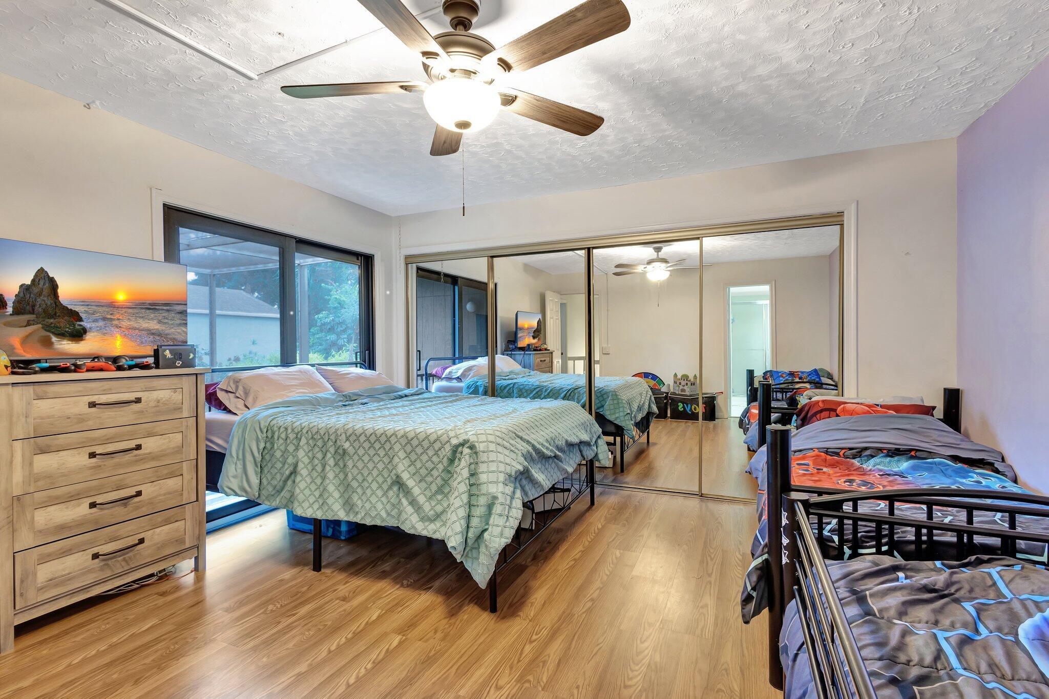 2936 Kirk Road Lake Worth Beach, FL 33461 - Photo 19 of 19 a spacious bedroom with a bed and ceiling fan