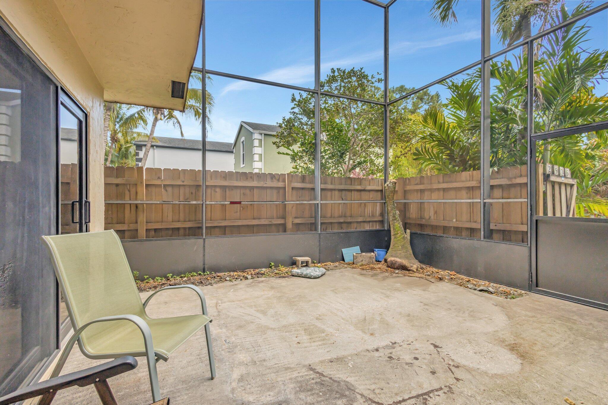 2936 Kirk Road Lake Worth Beach, FL 33461 - Photo 2 of 19 a view of a chairs and table in the patio