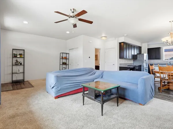 a living room with furniture and a kitchen