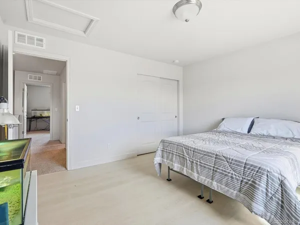 a bedroom with a bed and chandelier