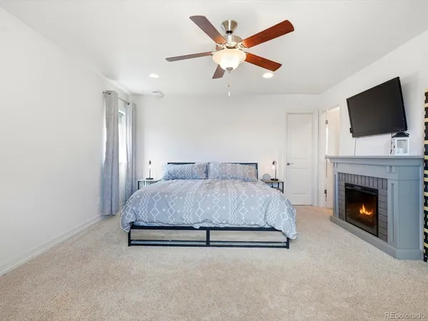 a spacious bedroom with a large bed and a flat screen tv