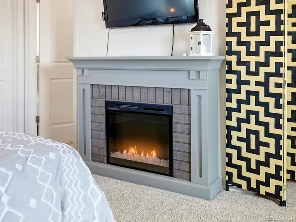 a living room with a fireplace and a flat screen tv