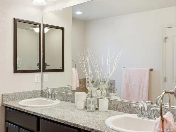 a bathroom with double vanity sinks and a mirror