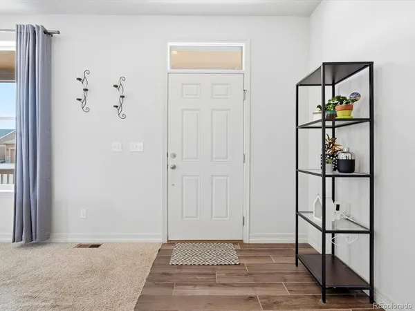 a view of an entryway with wooden floor