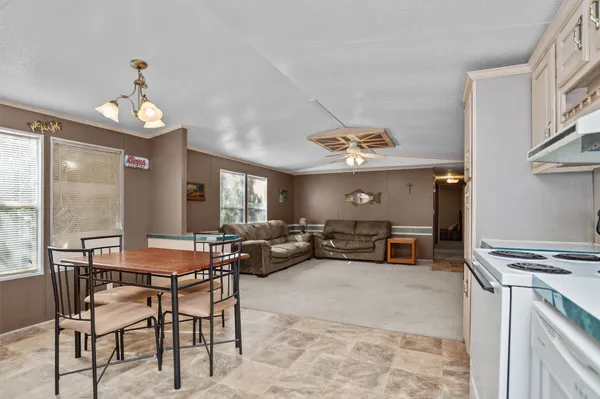 a view of a dining room with furniture wooden floor and chandelier