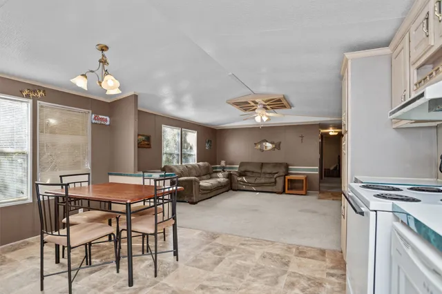 a view of a dining room with furniture wooden floor and chandelier