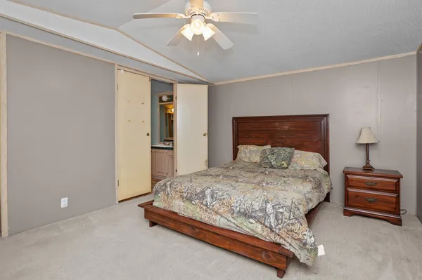 a bedroom with a bed and window