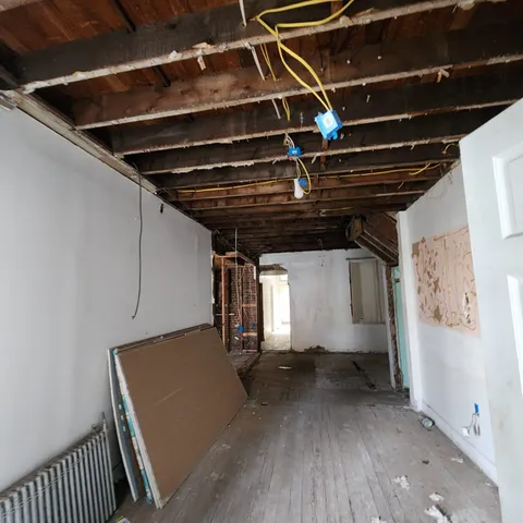 a view of a room with wooden floor