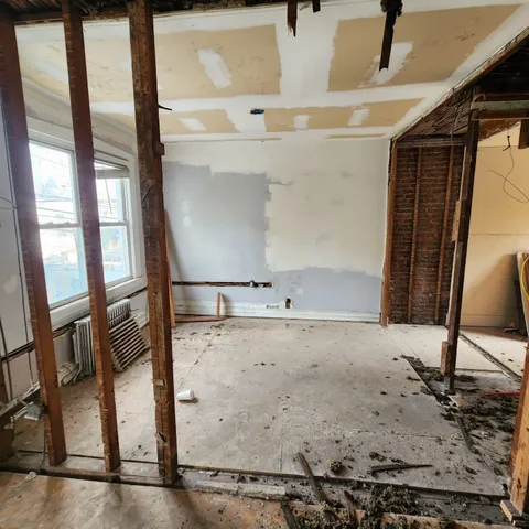 a view of a livingroom with wooden floor and window