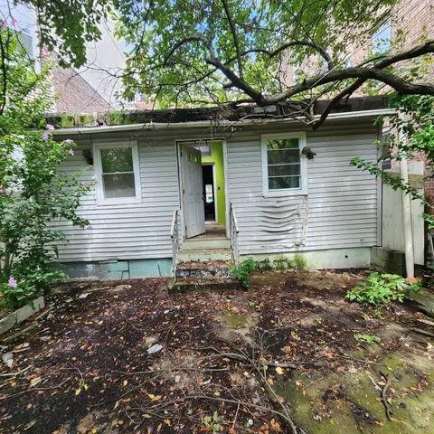 a view of house with backyard