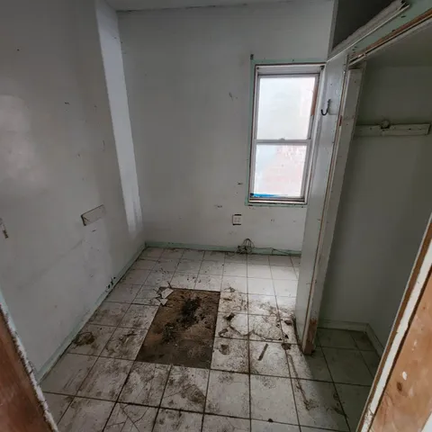 a room with water heater and a wooden door