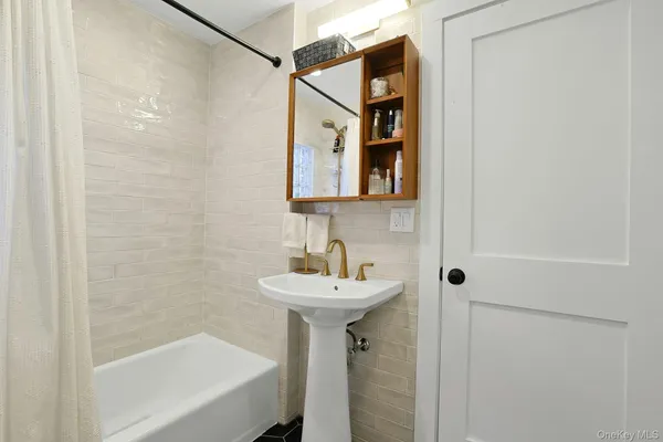 a bathroom with a sink a mirror and a bathtub