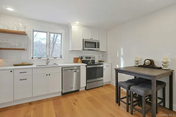a kitchen with a sink cabinets and wooden floor
