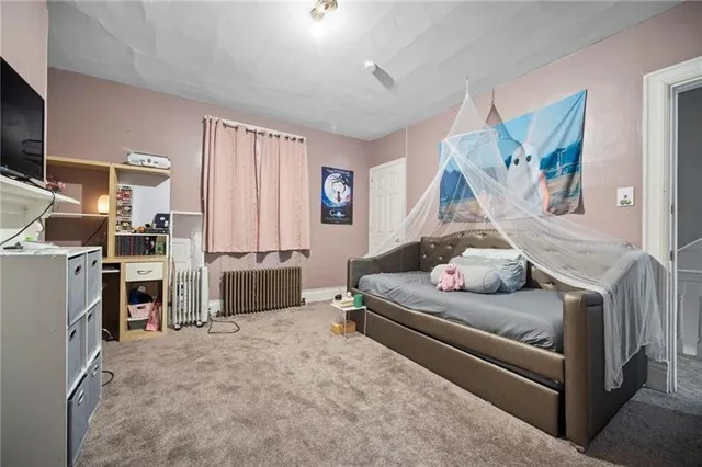 a bedroom with furniture and a flat screen tv