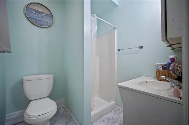 a bathroom with a toilet sink and vanity