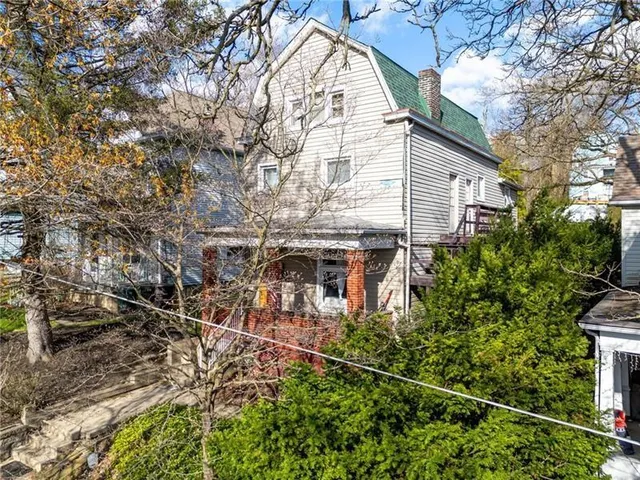 a view of a house with a tree