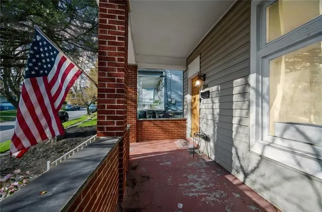 a view of a balcony with floor to ceiling windows with wooden floor