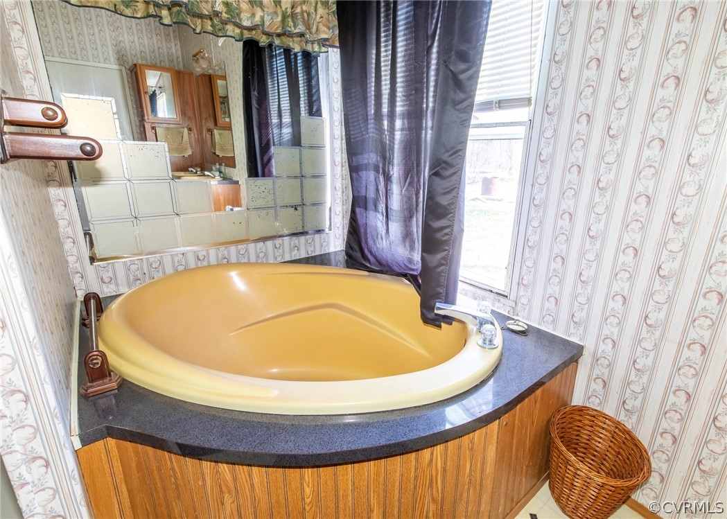 14306 Wilkinson Road Dewitt, VA 23840 - Photo 19 of 23 a bathroom with a sink and bathtub