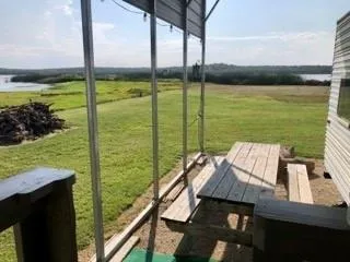 a backyard of a house with barbeque oven table and chairs