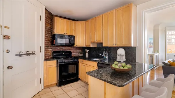 a kitchen with a stove a sink and a refrigerator