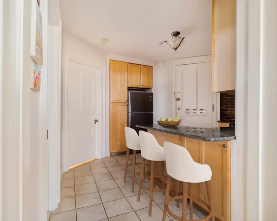 a living room with granite countertop furniture and a dining table
