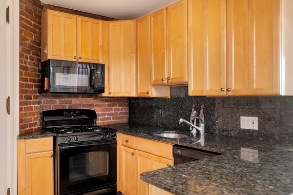 a kitchen with a stove a sink and a microwave