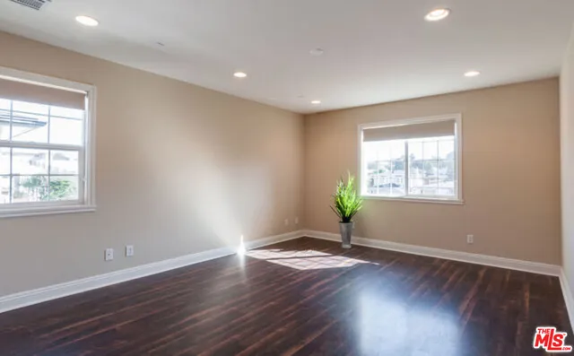 a view of wooden floor and windows in a room
