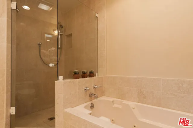 a bathroom with a bathtub and a shower