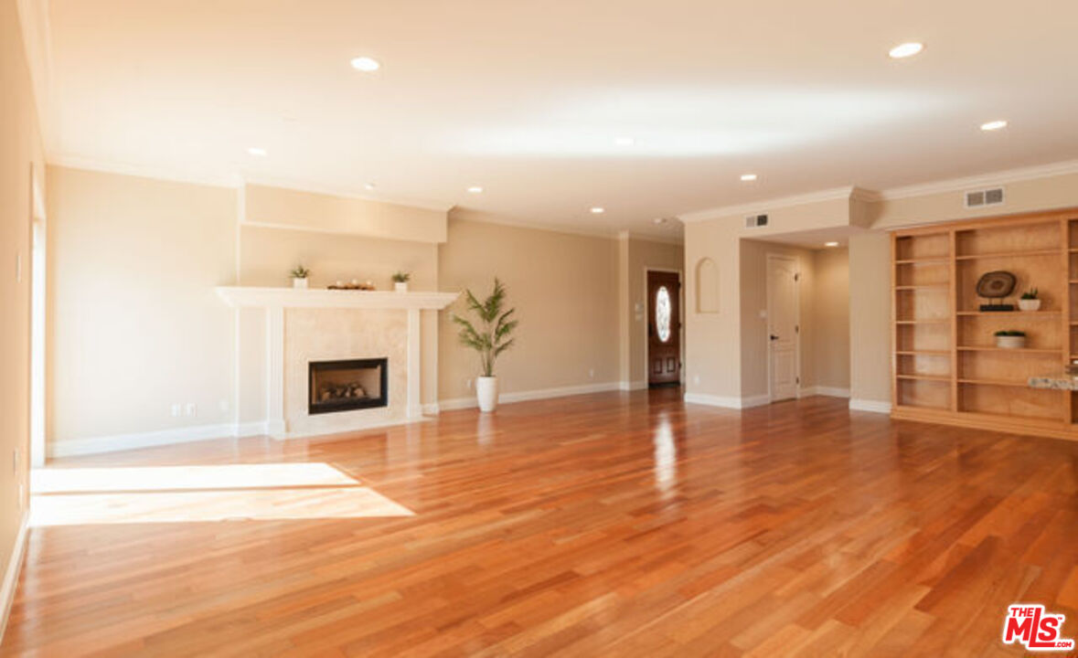 826 Main Street, Unit 6 El Segundo, CA 90245 - Photo 2 of 33 a view of a livingroom with a fireplace a ceiling fan and kitchen space