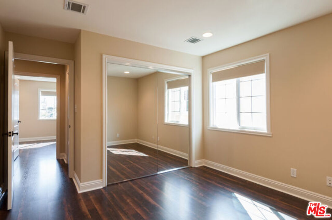 826 Main Street, Unit 6 El Segundo, CA 90245 - Photo 23 of 33 an empty room with wooden floor and windows