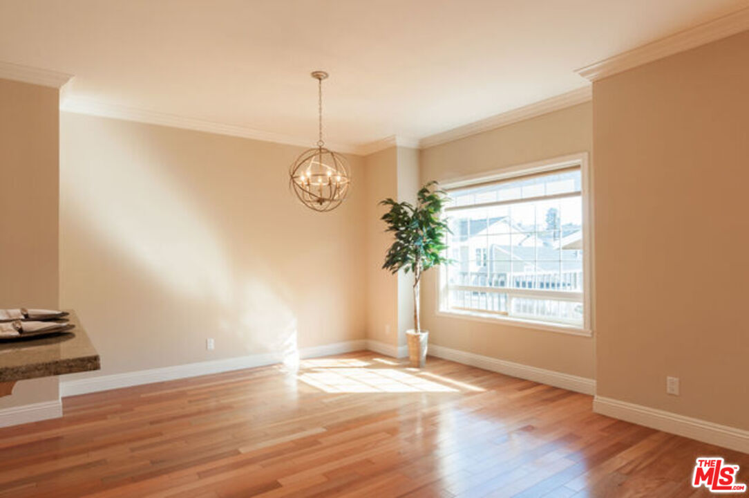 826 Main Street, Unit 6 El Segundo, CA 90245 - Photo 8 of 33 a view of an empty room with wooden floor and a window