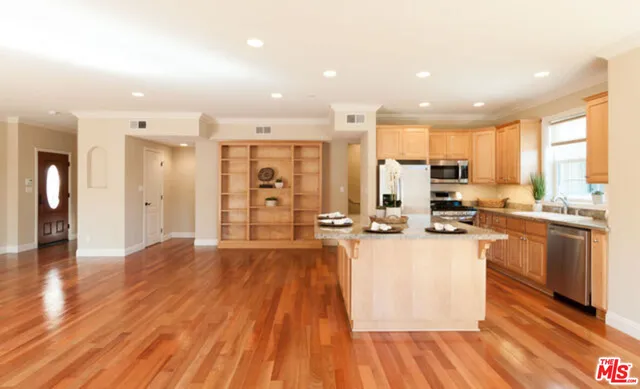 a kitchen with stainless steel appliances a refrigerator sink and cabinets