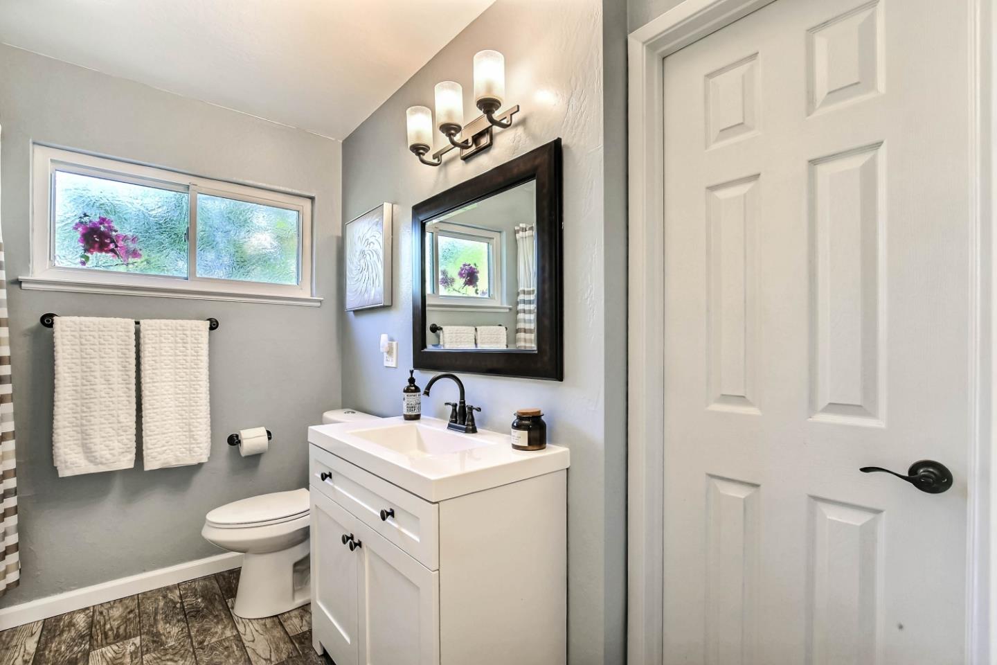 5085 Derek Drive San Jose, CA 95136 - Photo 11 of 18 a bathroom with a toilet a sink and mirror