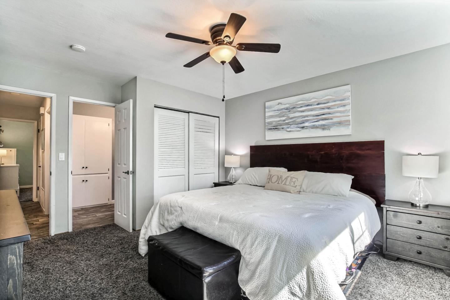 5085 Derek Drive San Jose, CA 95136 - Photo 9 of 18 a bedroom with a bed and a chandelier