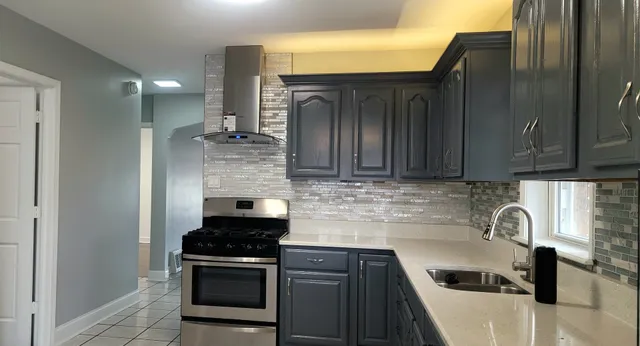 a view of a kitchen with granite countertop cabinets