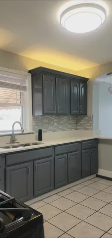 a kitchen with stainless steel appliances granite countertop a sink and cabinets