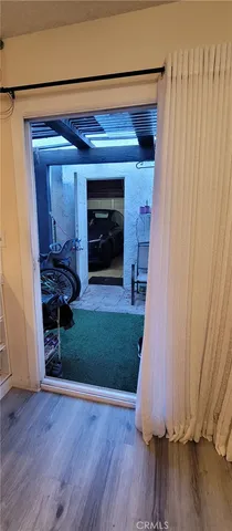 a bedroom with a bed and a flat tv screen on the dresser