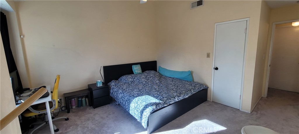 19221 Sherman Way, Unit 6 Reseda, CA 91335 - Photo 23 of 35 a bedroom with a bed and a flat tv screen on the dresser